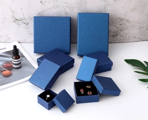 Macro shot of dark blue silk texture jewelry gift boxes for rings and necklaces