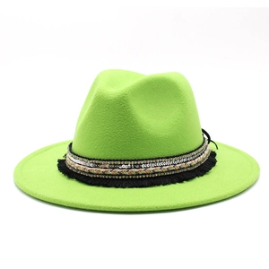 Detail of neon green fedora hat featuring multi-layer sequins and fringe ribbon