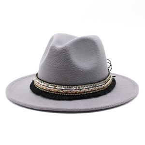 Detail of gray wool fedora hat featuring bohemian band with sequins and tassels