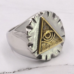 Detailed close-up of vintage stainless steel All-Seeing Eye ring on marble background