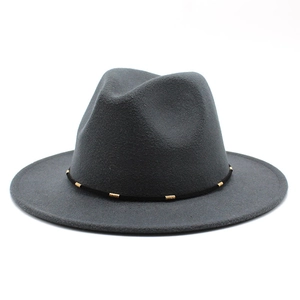 Detailed texture of dark grey wool felt fedora with gold metal buckle band trim