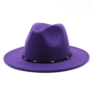 Close-up of purple wool fedora hat with black band and gold metallic pipe accents