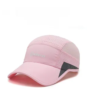 Close-up of pink quick-dry fabric with mesh ventilation and silver logo on kids sports cap
