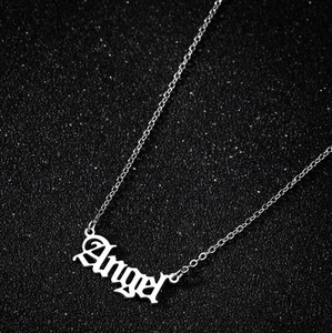 Macro shot of silver Angel pendant in Gothic font on a polished stainless steel chain