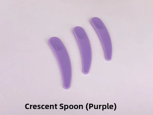 Three purple crescent cosmetic spatulas for cream application on a light background