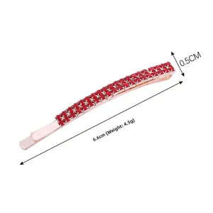 Detail view of 6.6cm double-row red rhinestone bobby pin with rose gold metal base