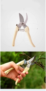 Detail view of gardening shears showing anti-slip handle and branch cutting action
