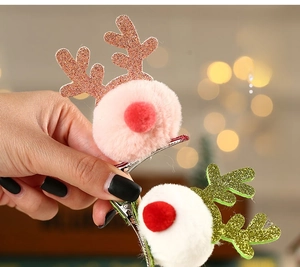 Detail of pink and white plush reindeer antler hair clips with festive glitter and red nose