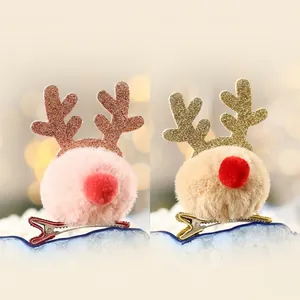 Detail view of pink and yellow plush reindeer antler hair clips with glitter accents
