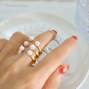 Baroque freshwater pearl open ring set in matte gold finish worn on fingers
