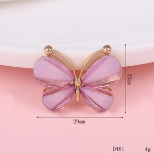 Macro view of a 29mm purple rhinestone butterfly charm accessory with golden base