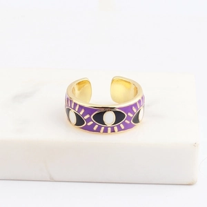 Detailed close-up of a purple enamel evil eye open ring on a white marble stand