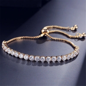 Macro shot of gold adjustable tennis bracelet with sparkling round clear zircons