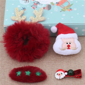 Detail of Christmas hair clips set featuring Santa and reindeer plush with glitter horns