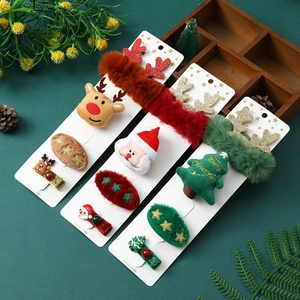 Christmas hair clip gift set with Santa, reindeer, and tree designs on green background