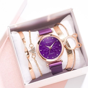 Detail view of purple dial watch and rose gold bracelets in a luxury white gift box