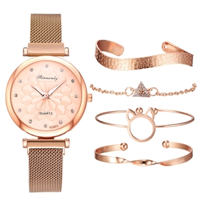 Detail of rose gold mesh strap watch with sparkling rhinestone bangles and bracelets