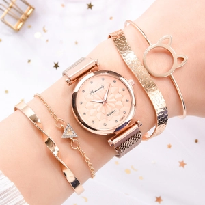 Close-up of rose gold watch and cat ear bracelets set worn on a model's wrist