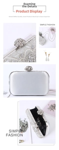Detail of silver evening clutch with pearls, rhinestones, and elegant metal floral clasp