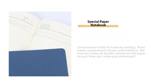 Macro detail of lined special paper pages and dark blue cover of an A5 notebook