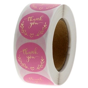 Pink round thank you labels with gold foil heart and floral wreath on a roll