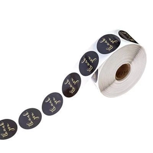 Roll of 1 inch black round stickers with gold foil thank you text for gift packaging