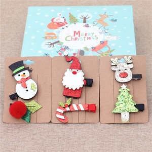 Detailed view of three Christmas hair clips featuring Snowman, Santa, and Reindeer themes