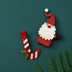 Detail of Christmas clips featuring glittery Santa Claus and striped candy cane designs