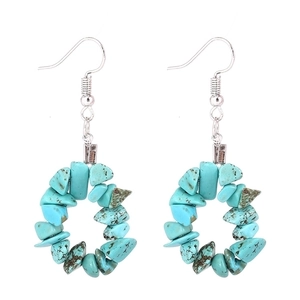 Detail view of bohemian turquoise stone beads arranged in a circular hoop drop earring