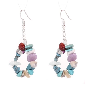 Detail of bohemian teardrop earrings made with colorful natural crushed stone beads