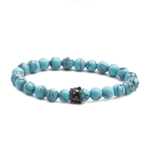 8mm blue turquoise bead bracelet with a black crown charm and natural stone textures