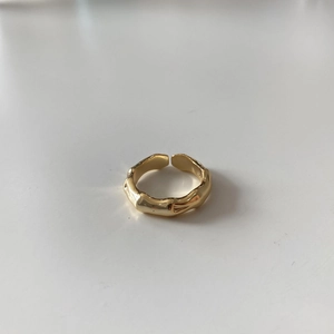 Macro shot of gold bamboo texture open ring detail with minimalist silver craft
