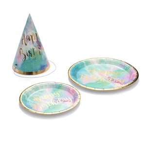 Detail of nebula party hats and paper plates with golden Happy Birthday lettering