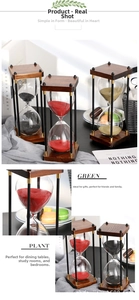 Close-up of vintage wooden hourglass timer with colorful sand and rustic decor