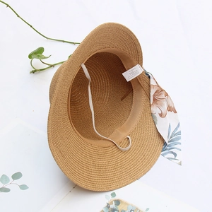 Women's foldable straw sun hat with floral ribbon bow and wide brim for beach