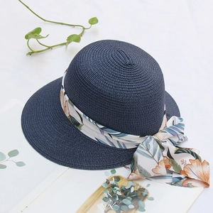 Navy blue straw sun hat with floral ribbon bow and wide brim for summer beach vacation