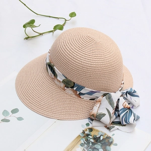 Straw sun hat with floral ribbon bow and wide brim for summer outdoor beach vacation