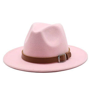 Detailed macro view of pink felt fedora with brown leather band and metal buckle strap