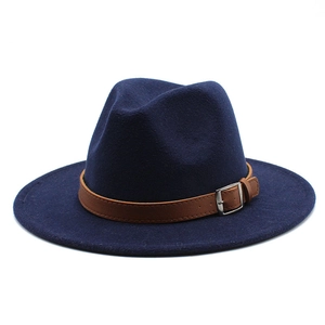 Detail of navy wool fedora hat featuring brown synthetic leather band and silver buckle