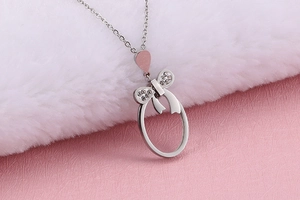 Macro shot of silver titanium necklace featuring a bow pendant with white rhinestones