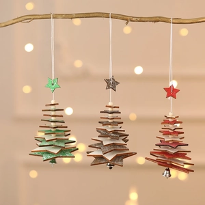 Three wooden Christmas tree ornaments with bells in red, green and brown hanging on branch