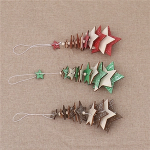 Three stacked wooden star Christmas ornaments with bells on rustic burlap background