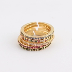 Stackable gold adjustable rings with multi-colored gemstones on a clean white background