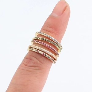 Stackable gold rings for women with colorful micro-pave cubic zirconia on white background