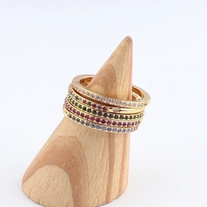Set of 5 gold-plated rings with colorful zircon stones on a wooden display stand