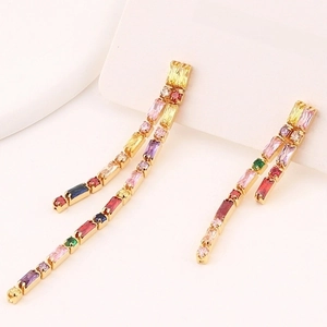Detail of long tassel earrings with colorful rectangular zircons in gold-tone setting