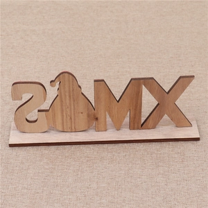 Detail of wooden Christmas letter ornaments with rustic Santa Claus silhouette and natural texture