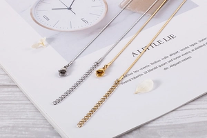 Detailed view of gold and silver geometric eye necklaces with lobster clasps and extenders