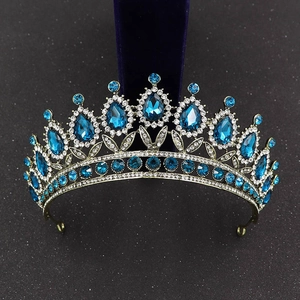 Detailed close-up of Baroque crown featuring blue teardrop gemstones on a bronze base