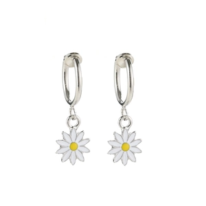 Pair of silver daisy drop earrings with white petals and yellow centers on white background